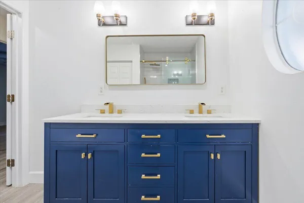 a bathroom with a sink a vanity and a mirror