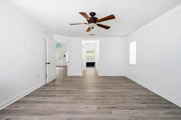 wooden floor in an empty room with a window