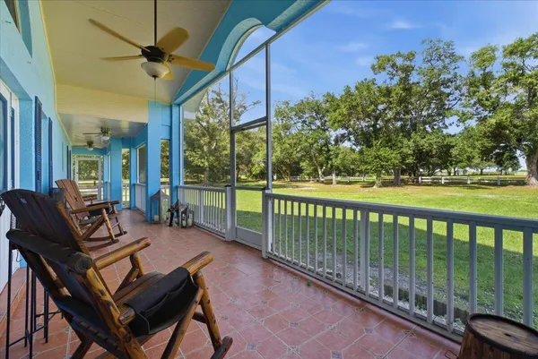 a view of a patio with a table chairs and a backyard