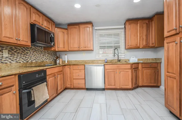 a kitchen with cabinets a sink and appliances