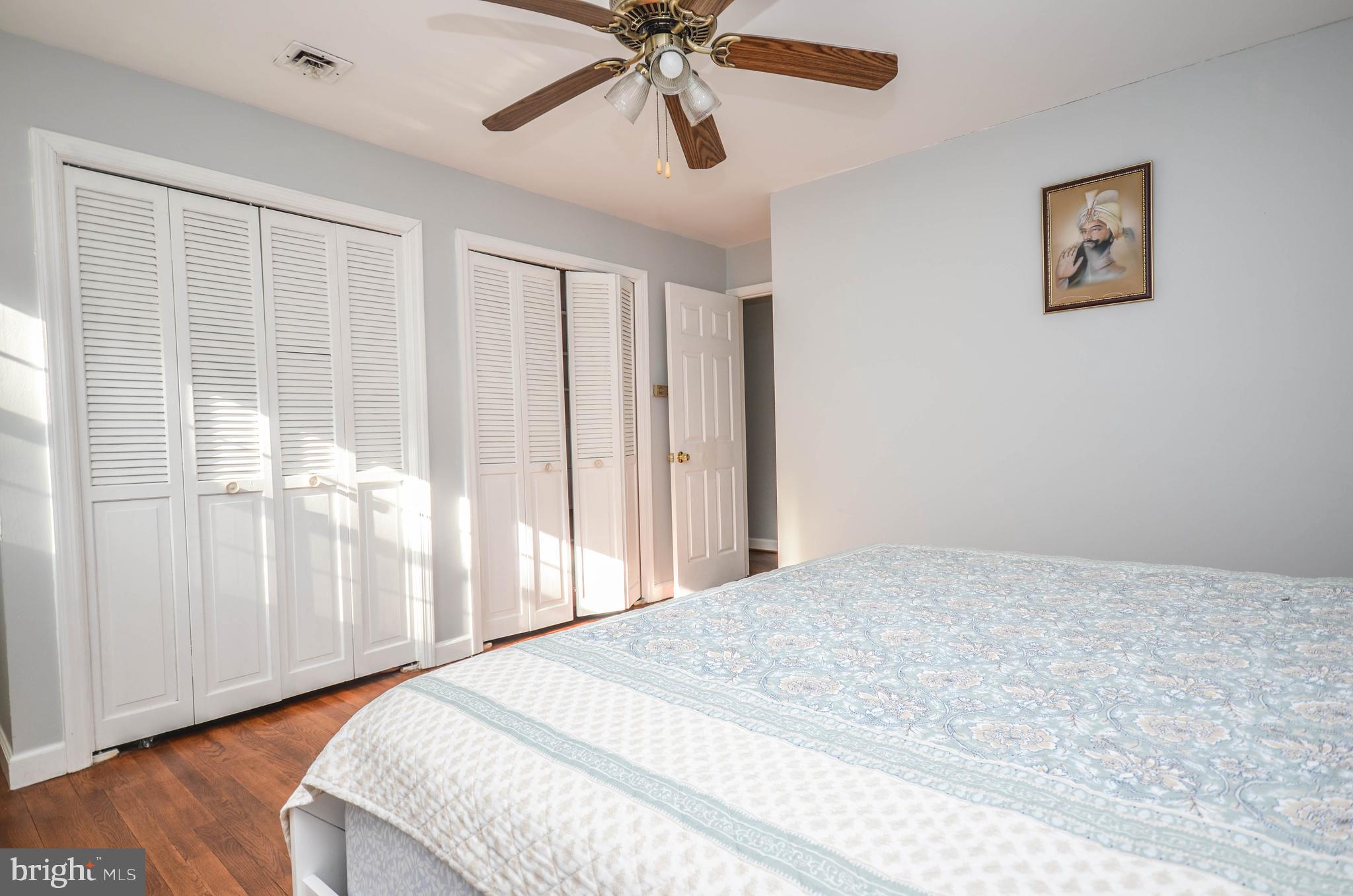 9801 Belhaven Road Bethesda, MD 20817 - Photo 14 of 32 a bedroom with a large bed and a window