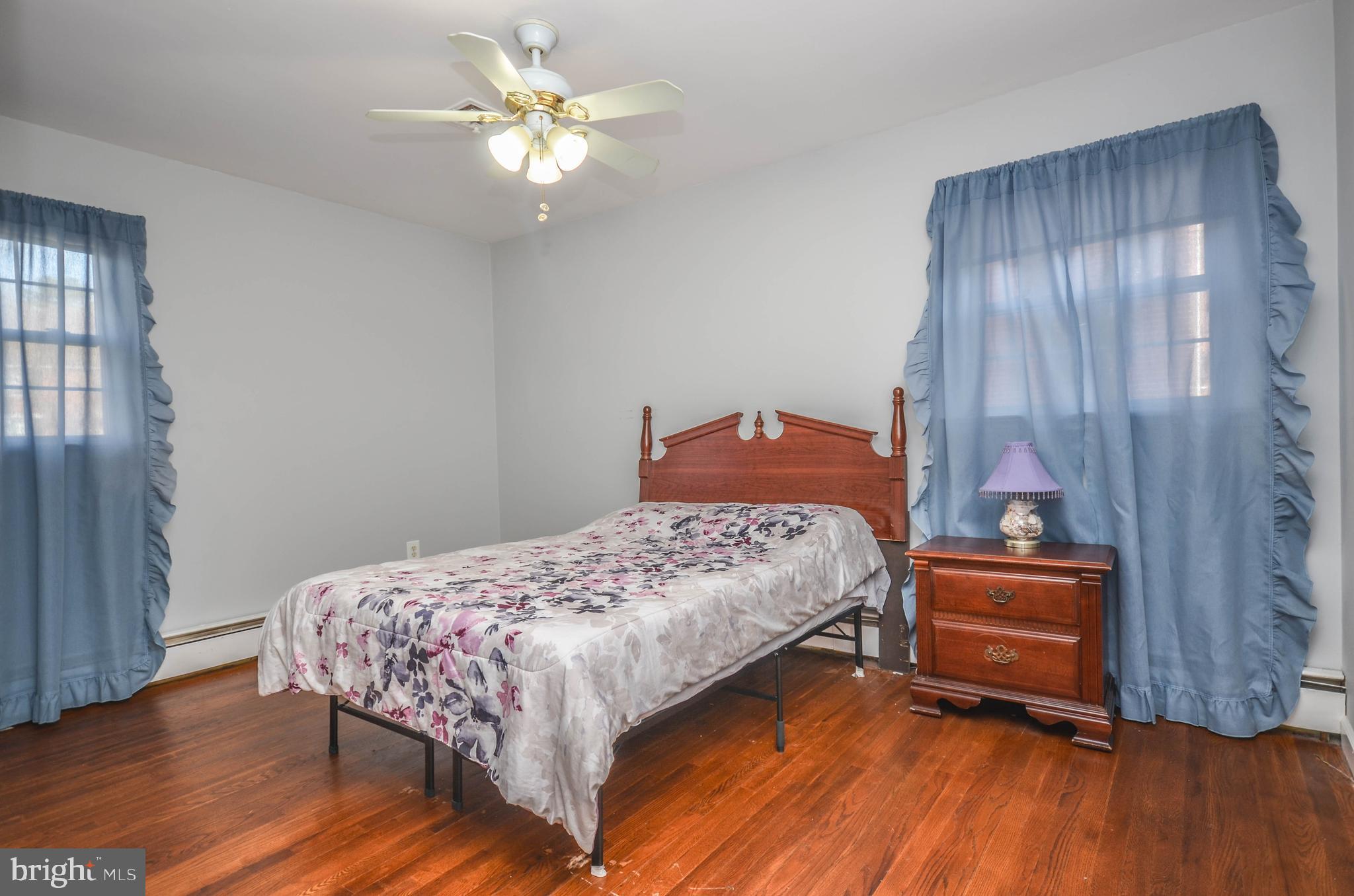 9801 Belhaven Road Bethesda, MD 20817 - Photo 16 of 32 a bedroom with a bed and a chandelier