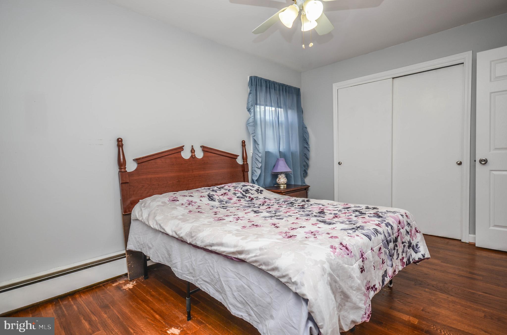 9801 Belhaven Road Bethesda, MD 20817 - Photo 17 of 32 a bedroom with a bed and a chandelier