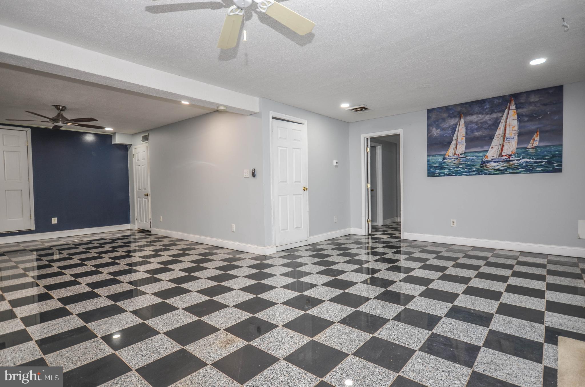9801 Belhaven Road Bethesda, MD 20817 - Photo 23 of 32 a room with a black white checkered floor