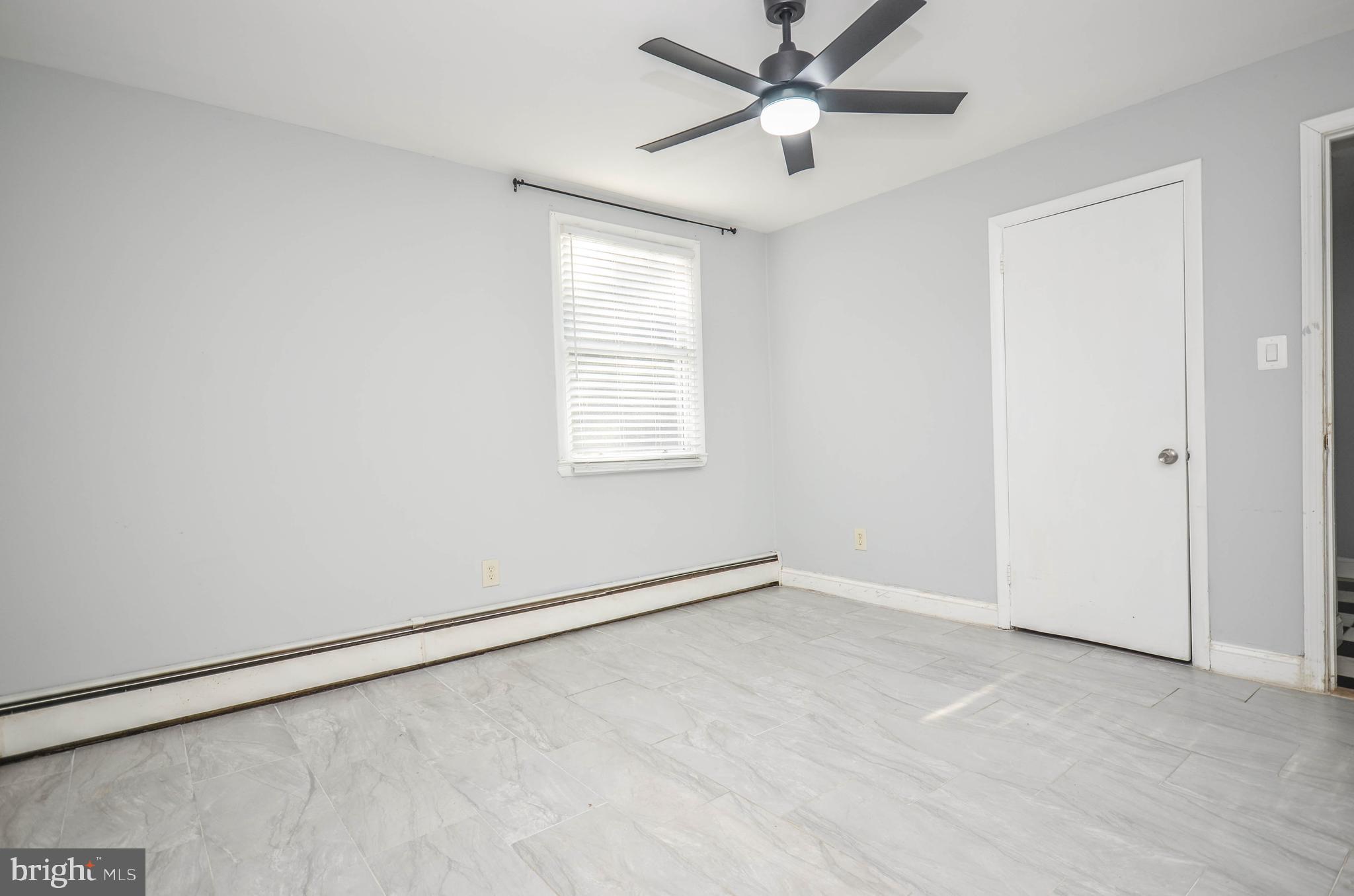 9801 Belhaven Road Bethesda, MD 20817 - Photo 26 of 32 an empty room with a window and a fan