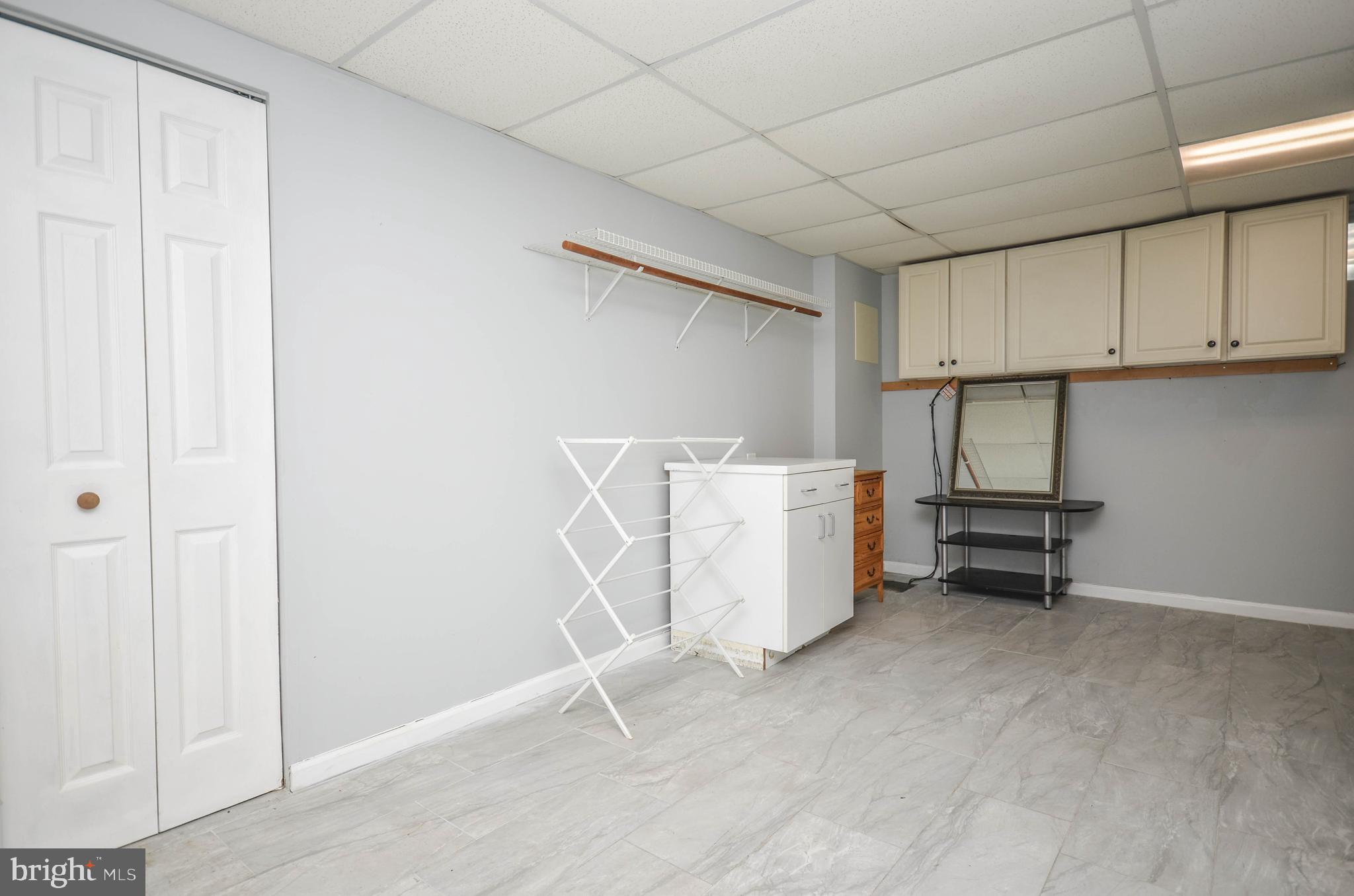 9801 Belhaven Road Bethesda, MD 20817 - Photo 27 of 32 an empty room with a cabinet and a window