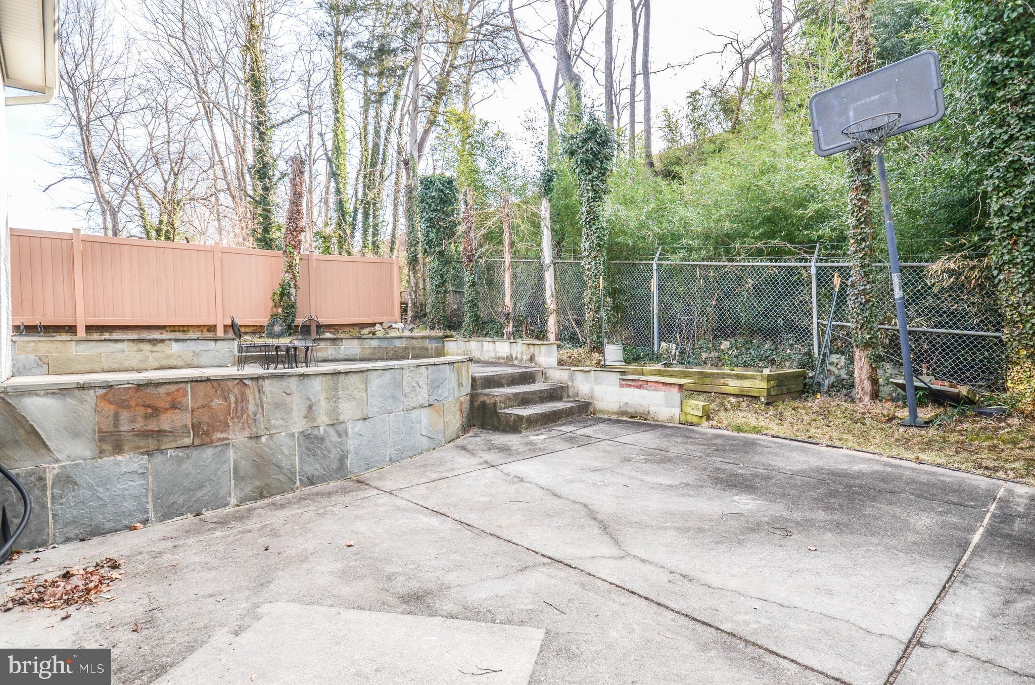 9801 Belhaven Road Bethesda, MD 20817 - Photo 30 of 32 a view of a swimming pool with a lounge chair