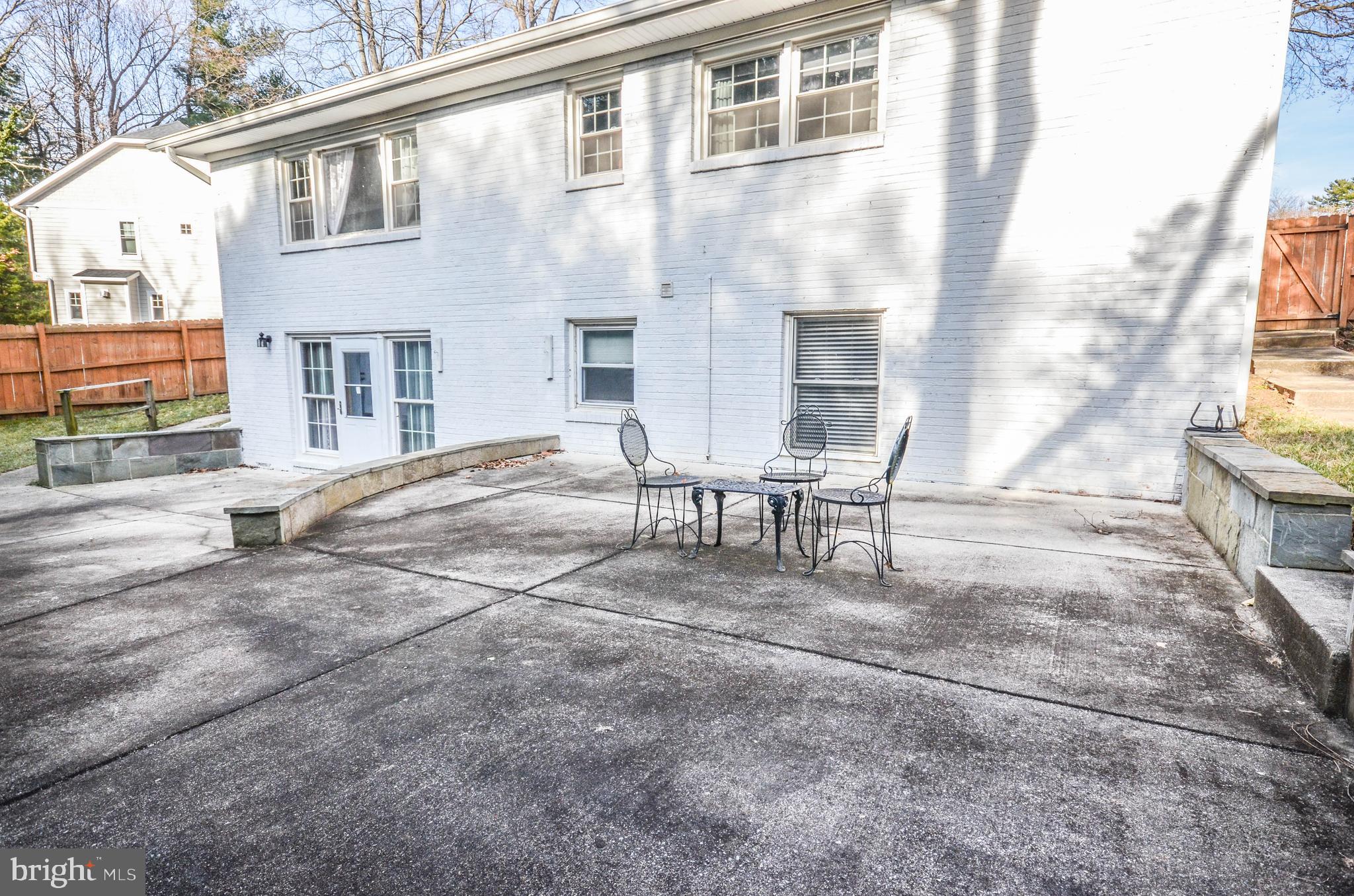 9801 Belhaven Road Bethesda, MD 20817 - Photo 31 of 32 a view of a patio with a table and chairs and potted plants