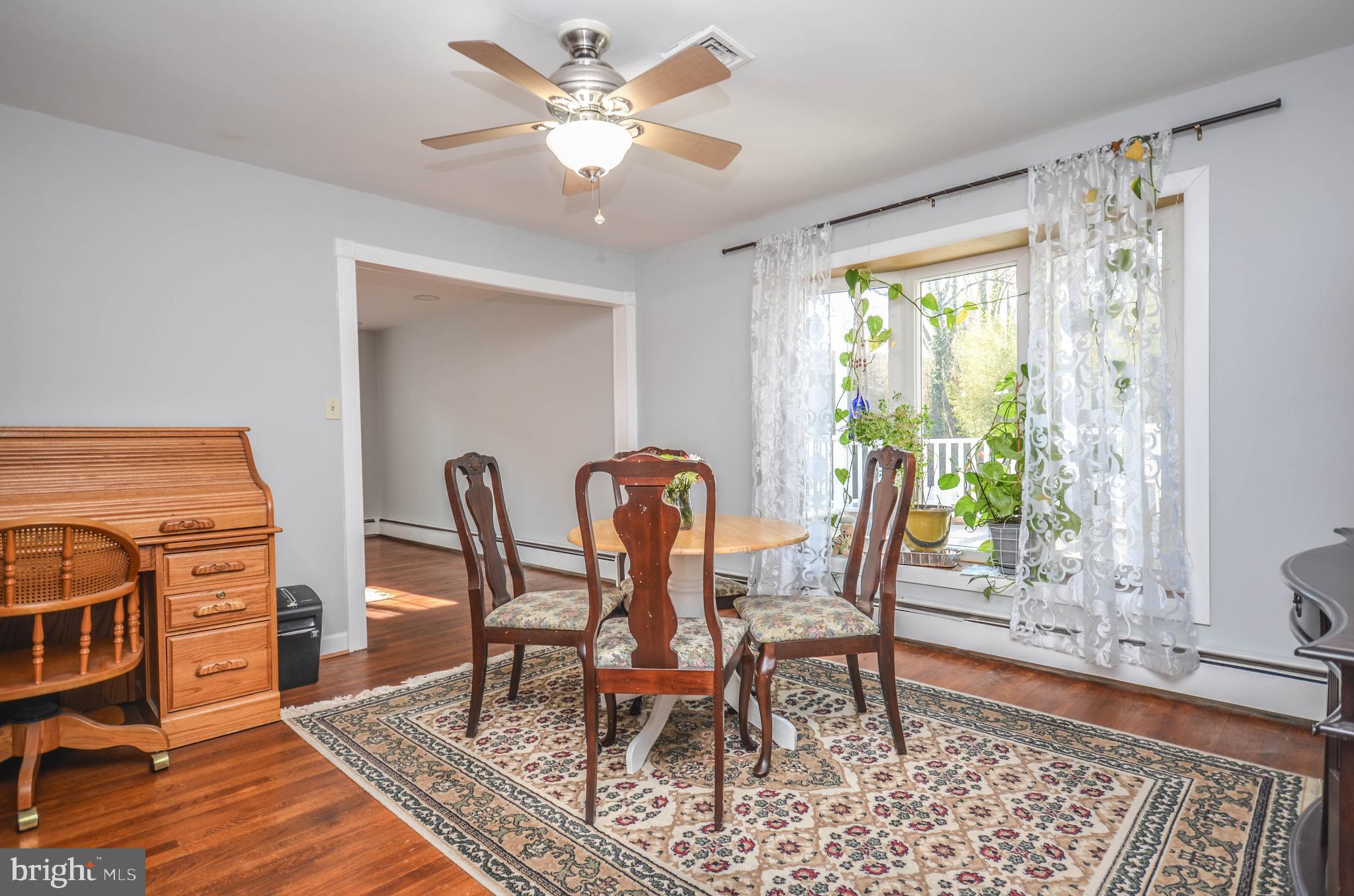 9801 Belhaven Road Bethesda, MD 20817 - Photo 5 of 32 a dining room with furniture a rug a chandelier and wooden floor