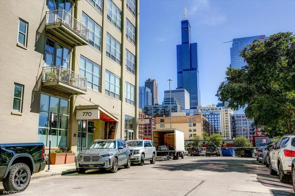 a city street with cars parked in front of it