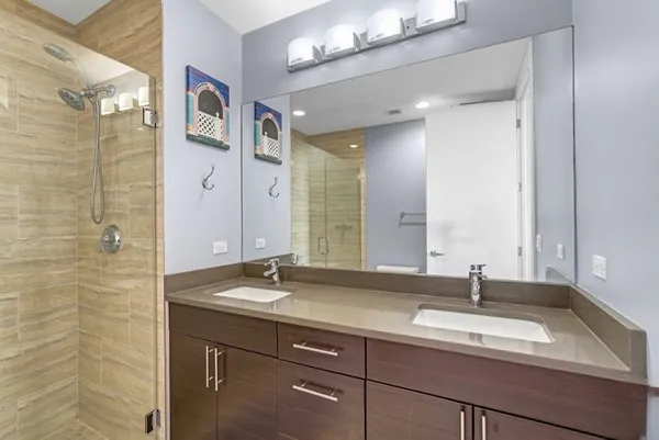 a bathroom with a double vanity sink and a mirror