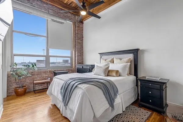a bedroom with a bed and a potted plant