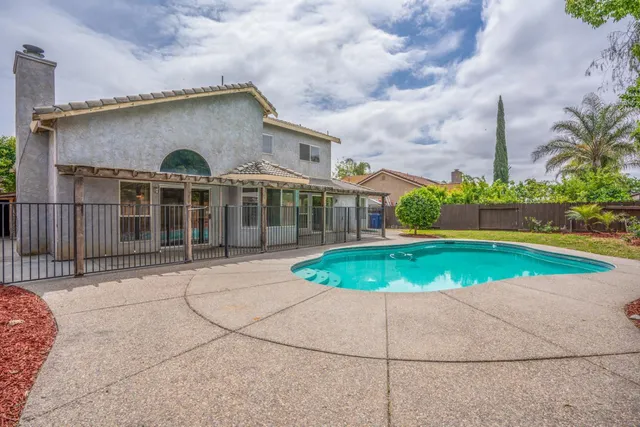 an aerial view of a house with a yard and potted plants