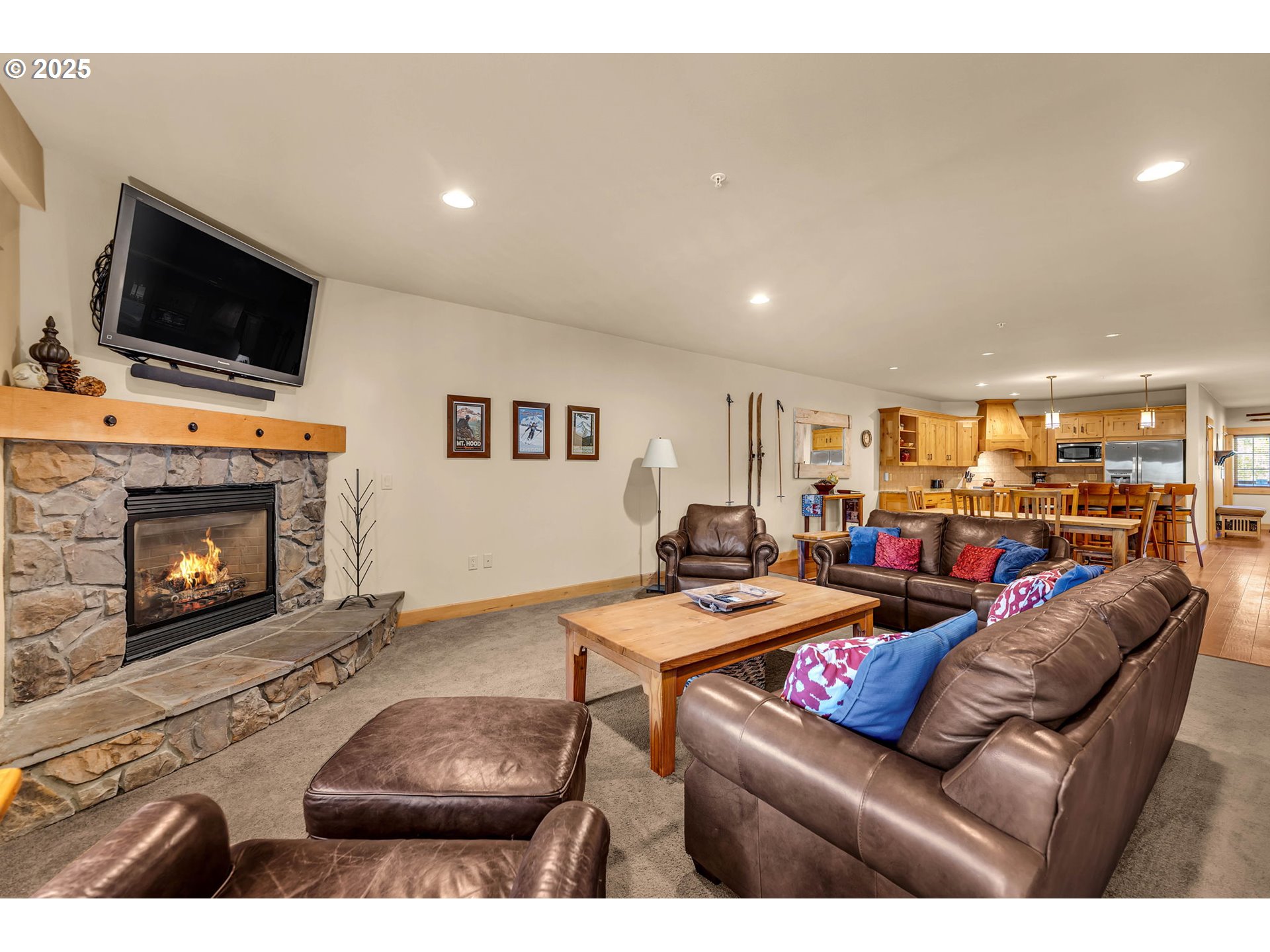 31254 East Collins Lake Road, Unit 22 Government Camp, OR 97028 - Photo 3 of 44 a living room with furniture a flat screen tv and a fireplace