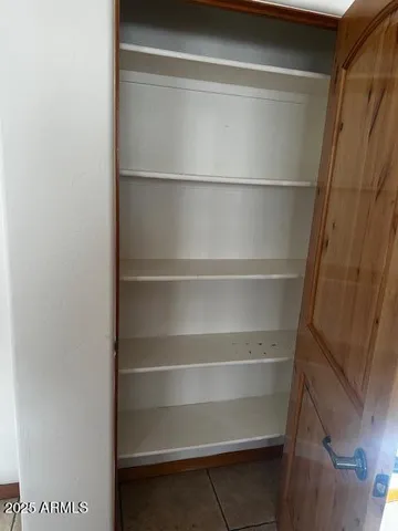 a view of walk in closet with empty racks
