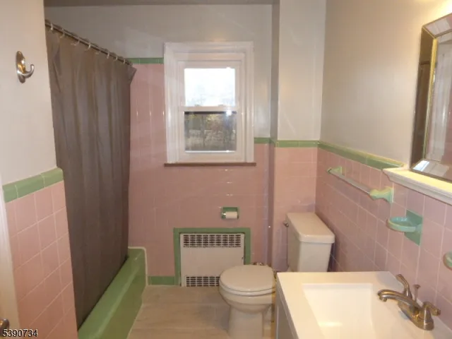 a white toilet sitting next to a bathroom sink and tub