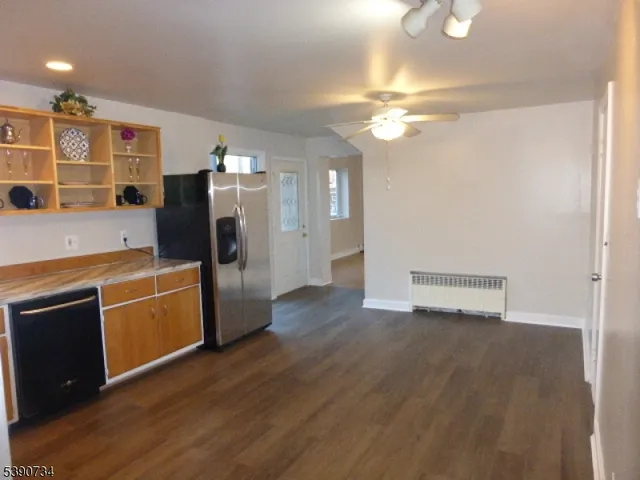 a kitchen with stainless steel appliances a refrigerator and a stove top oven