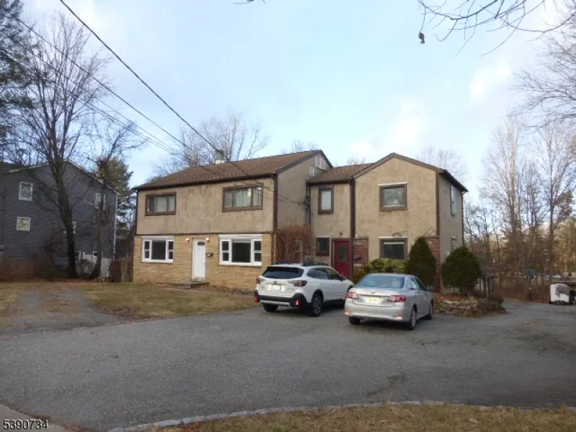 a car parked in front of white house