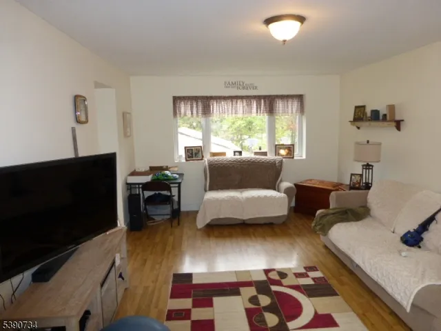 a view of backyard with deck and outdoor seating