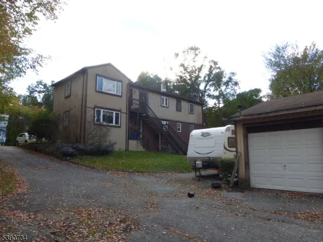 a view of a house with backyard and porch