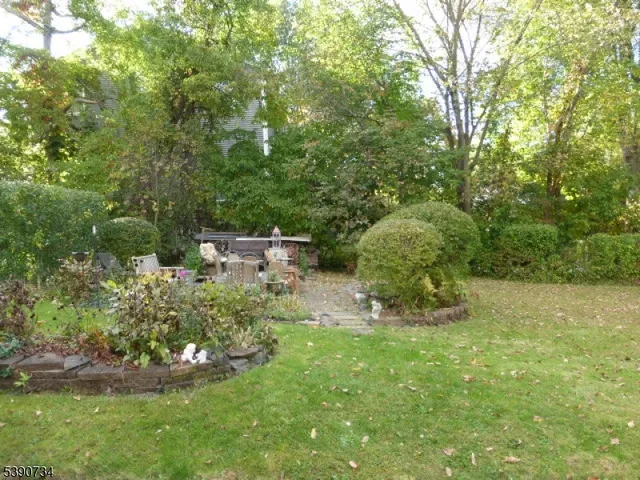 a view of a chair and table in backyard