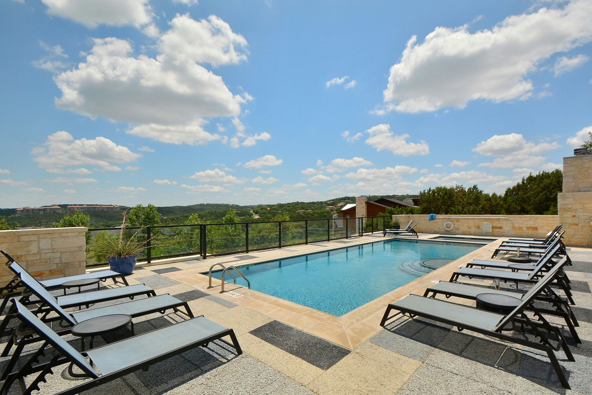 8110 Ranch Road 2222, Unit 92 Austin, TX 78730 - Photo 39 of 40 Outdoor swimming pool featuring a built-in spa, surrounding stone coping, and a spacious patio with varied paver finishes