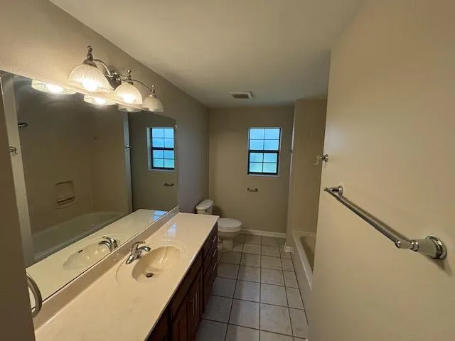 a bathroom with a sink mirror and shower