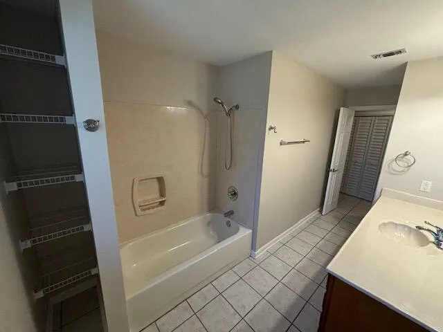 a bathroom with a tub sink and a mirror