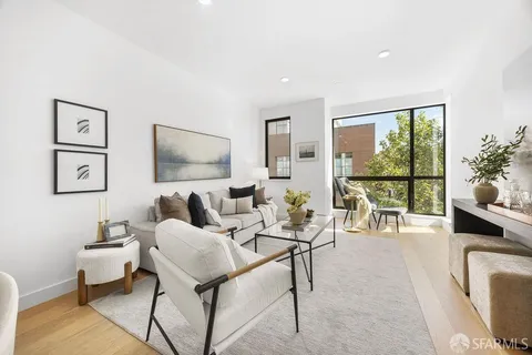 a dining room with furniture and a potted plant