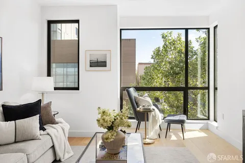 a living room with furniture and a potted plant