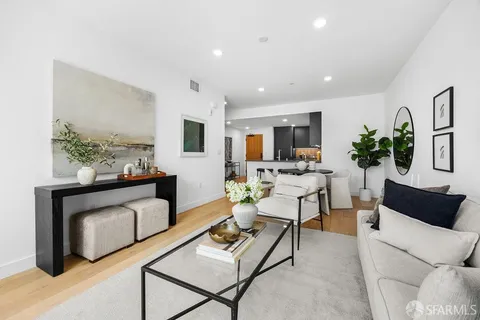 a kitchen with stainless steel appliances kitchen island granite countertop a refrigerator and a stove top oven