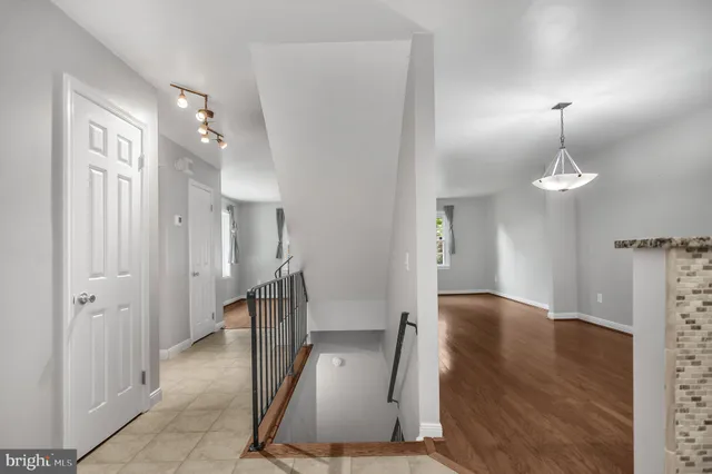 a view of a hallway with wooden floor and staircase