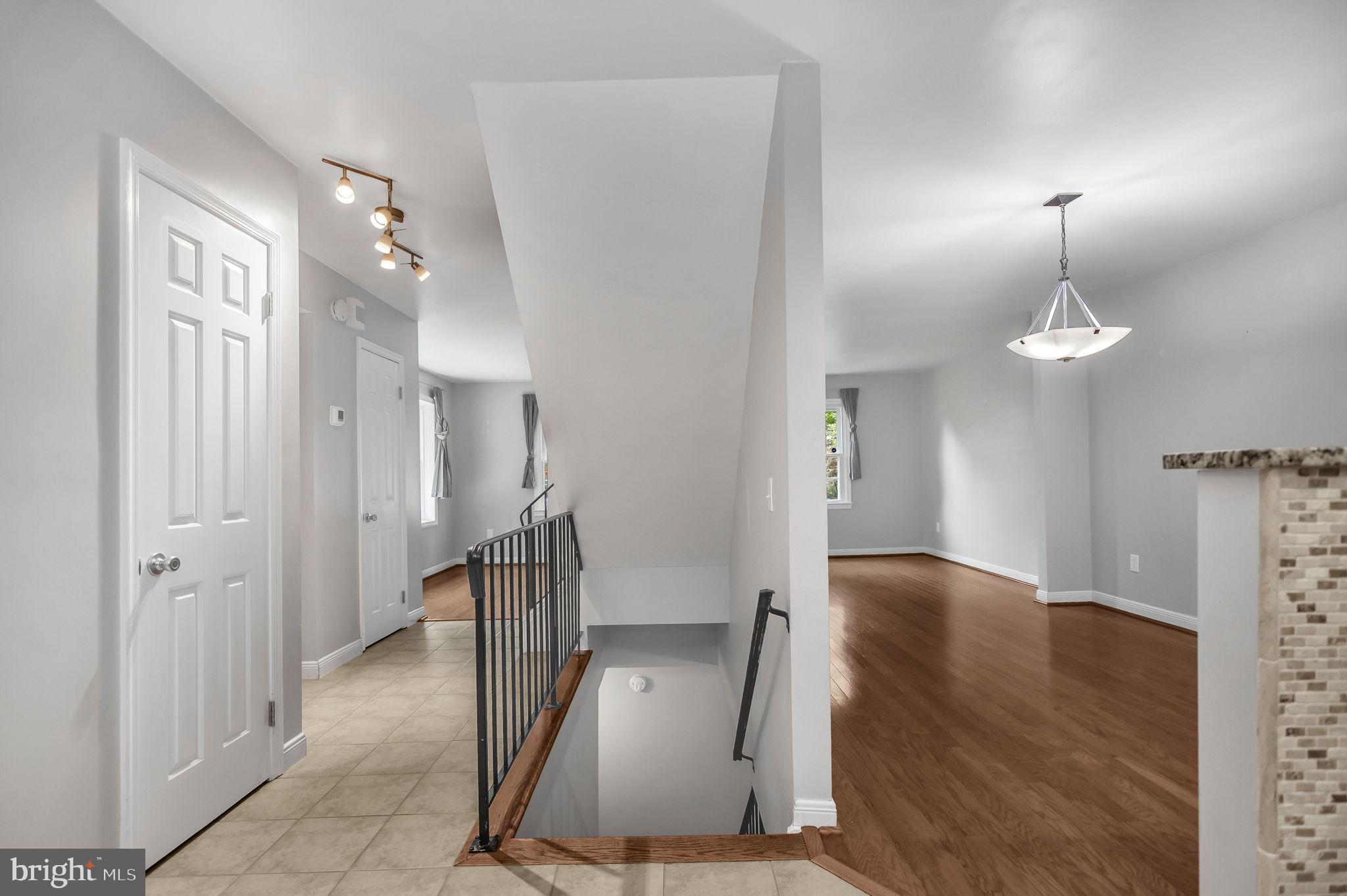 8914 Grandstaff Court Springfield, VA 22153 - Photo 13 of 48 a view of a hallway with wooden floor and staircase