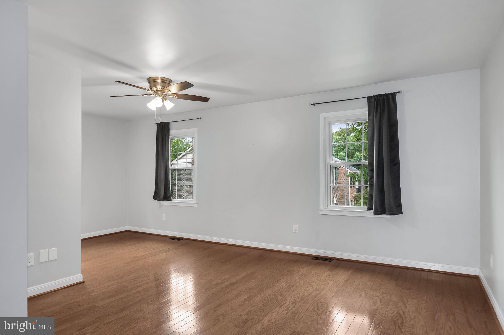 8914 Grandstaff Court Springfield, VA 22153 - Photo 15 of 48 a view of an empty room with a window and wooden floor