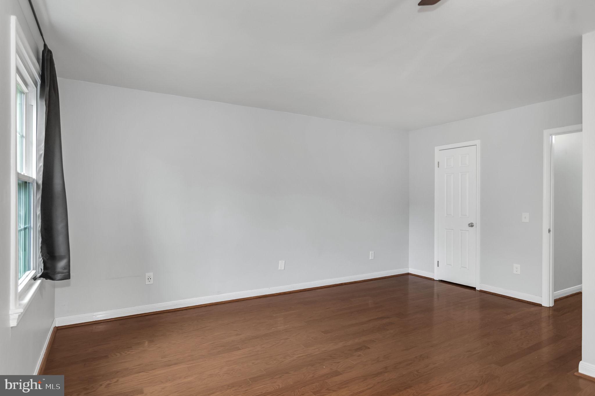 8914 Grandstaff Court Springfield, VA 22153 - Photo 17 of 48 a view of an empty room with wooden floor and a window