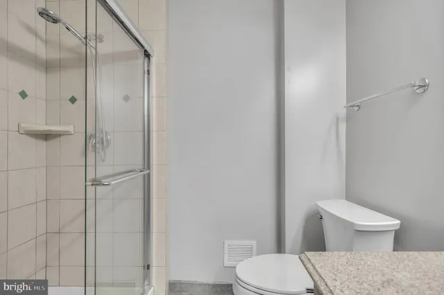 a white toilet sitting next to a bathroom sink