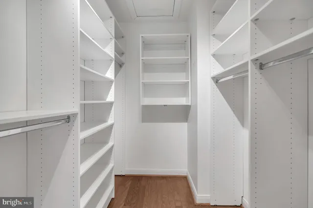 a view of walk in closet with empty racks