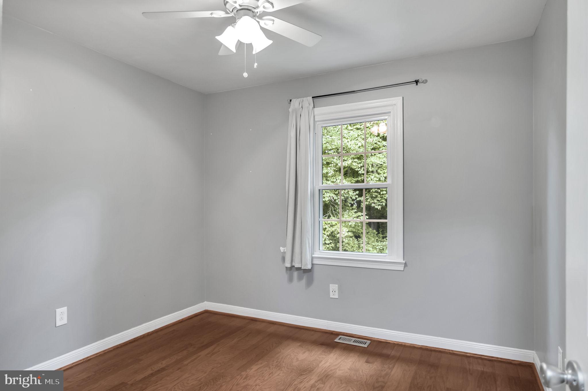 8914 Grandstaff Court Springfield, VA 22153 - Photo 22 of 48 an empty room with wooden floor and windows