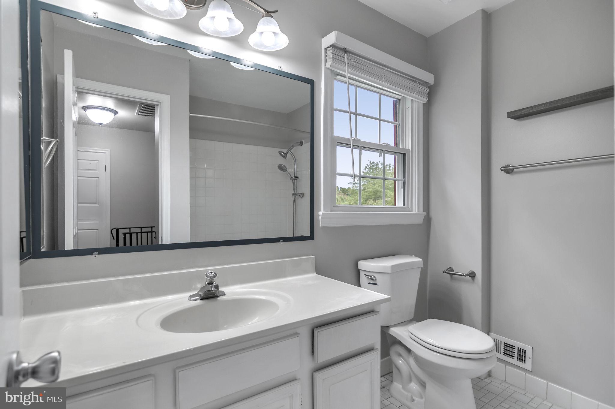 8914 Grandstaff Court Springfield, VA 22153 - Photo 26 of 48 a bathroom with a toilet a sink and a mirror