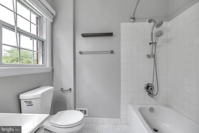 a white toilet sitting next to a bath tub shower