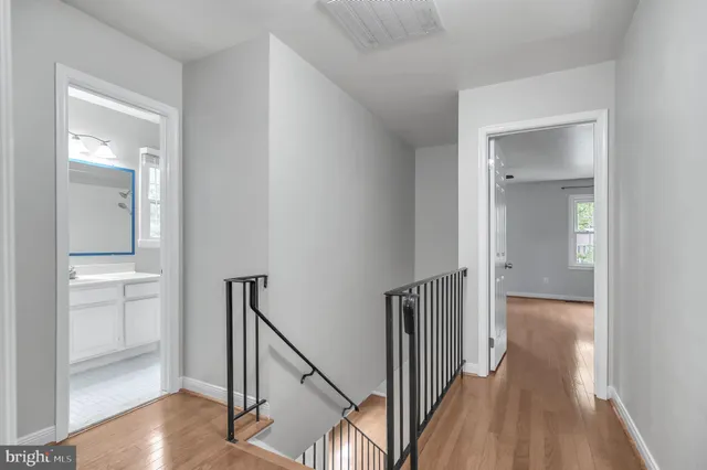a view of a hallway with wooden floor and entryway