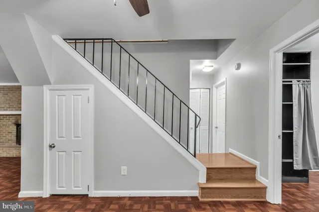 a view of staircase with lots of frames and a rug
