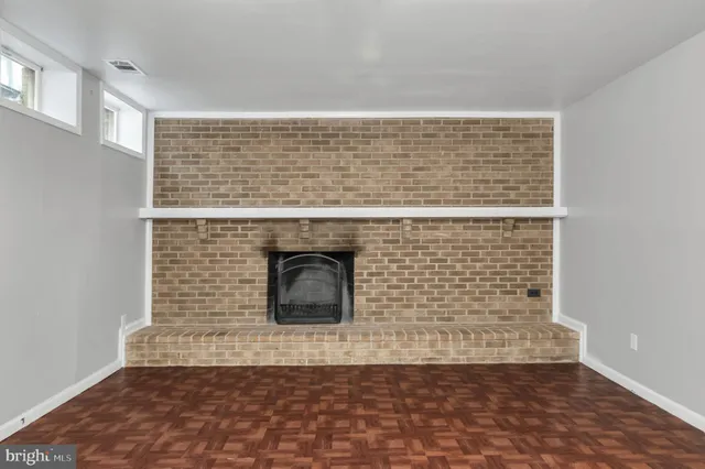 a view of empty room with a fireplace