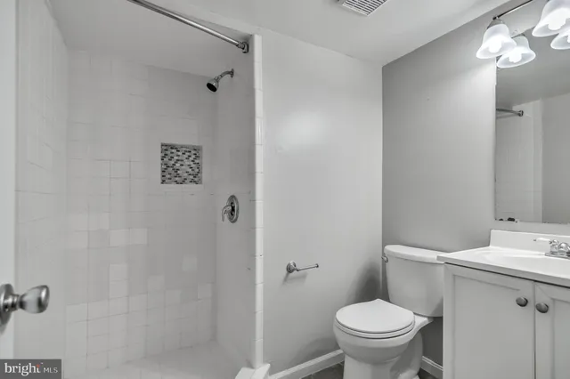 a white toilet sitting next to a bathroom sink