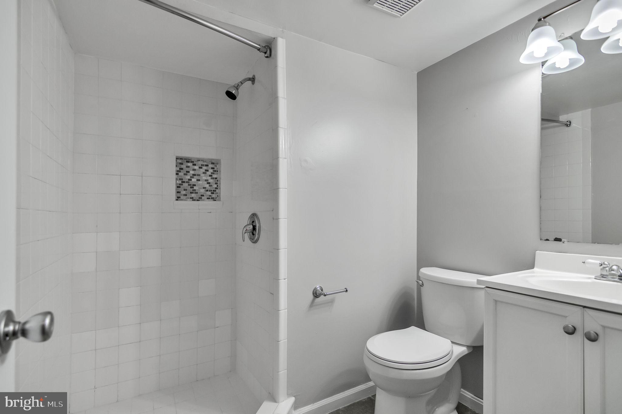 8914 Grandstaff Court Springfield, VA 22153 - Photo 37 of 48 a white toilet sitting next to a bathroom sink