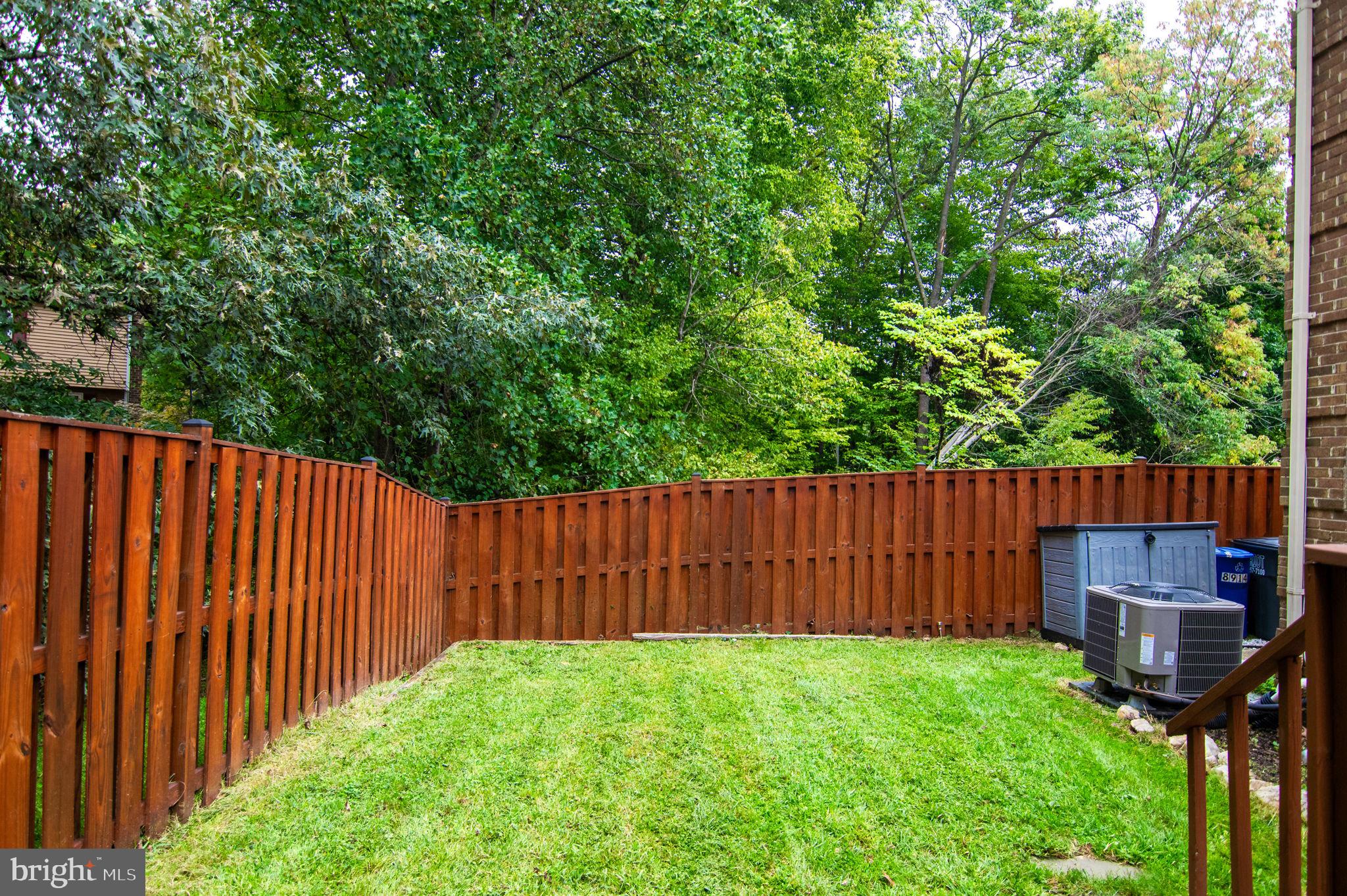 8914 Grandstaff Court Springfield, VA 22153 - Photo 43 of 48 a view of a backyard with wooden fence and a large tree