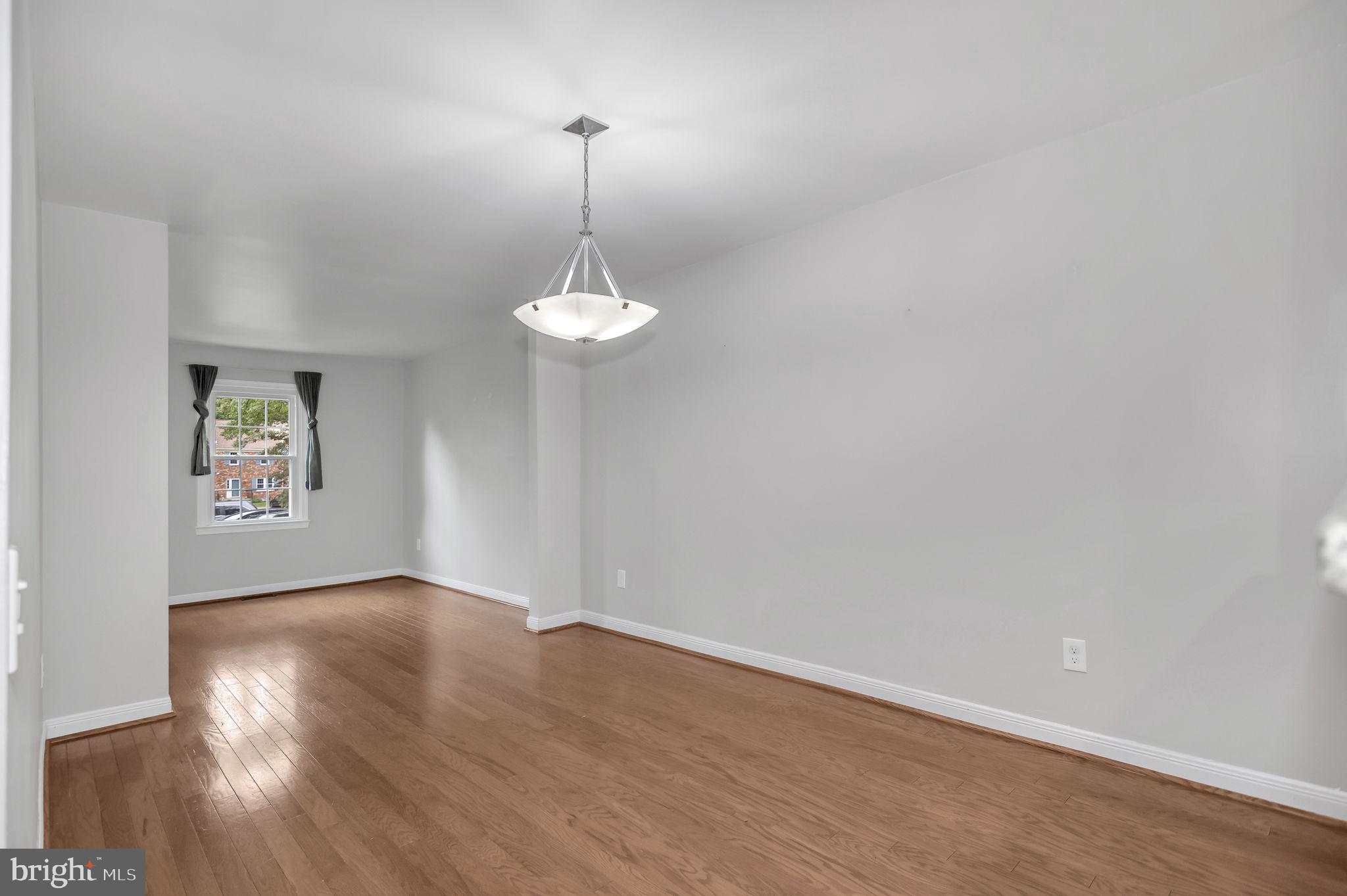 8914 Grandstaff Court Springfield, VA 22153 - Photo 7 of 48 a view of an empty room with a window and wooden floor