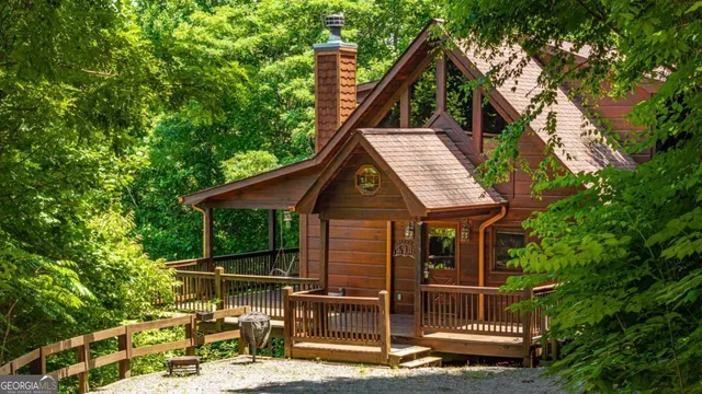 a view of a house with yard and sitting area
