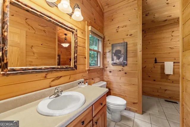 a bathroom with a double vanity sink toilet and shower