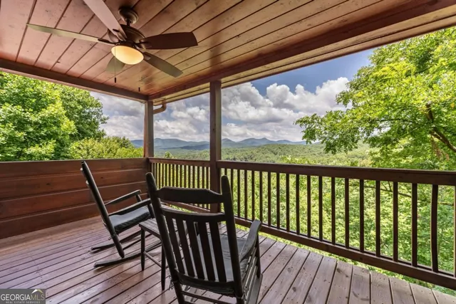 a view of a patio with table and chairs and wooden floor
